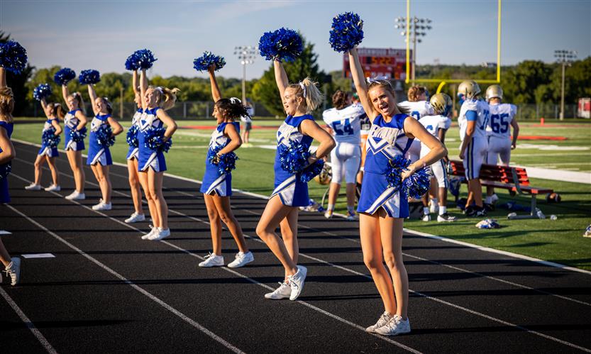 Cheerleaders cheer on the sidelines
